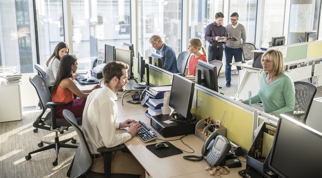 Call Center with colleagues consulting in the background